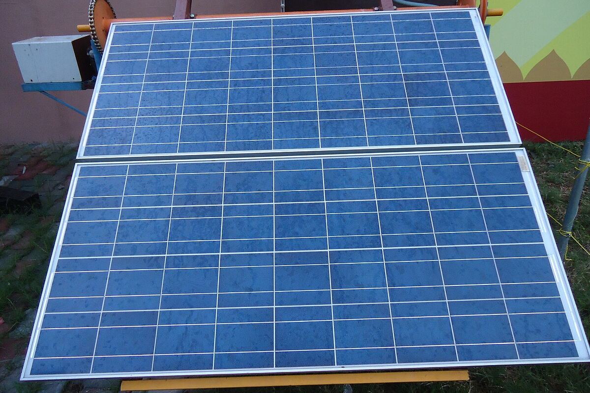 Flat RCC concrete rooftop solar installation with ballast-mounted panels on an Indian home