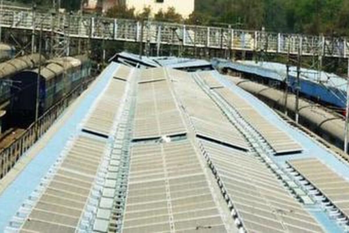 Solar panels rail-clamped to a corrugated metal warehouse roof in India